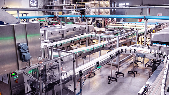 Dairy Manufacturing Plant with bottles of milk on a conveyor. Reaching water reduction potential. 