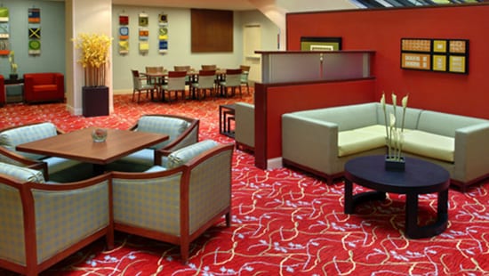 Modern Carpet Clean and vibrant carpets of a busy hotel lobby after receiving commercial carpet cleaning products.