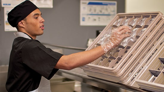 Dishwasher Placing Glasses in Rack DISHWASHING / WAREWASHING PROGRAMS, PRODUCTS, EQUIPMENT AND SERVICES