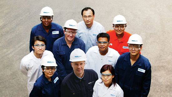 Group of people in hard hats and goggles - Ecolab