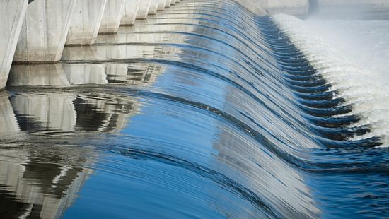 Rushing water flowing out of a dam from a wastewater treatment facility.