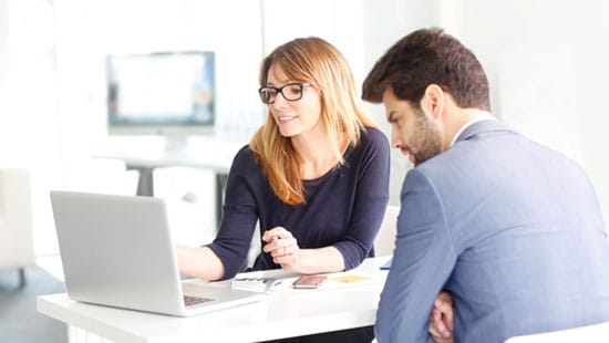 Two People looking at a computer